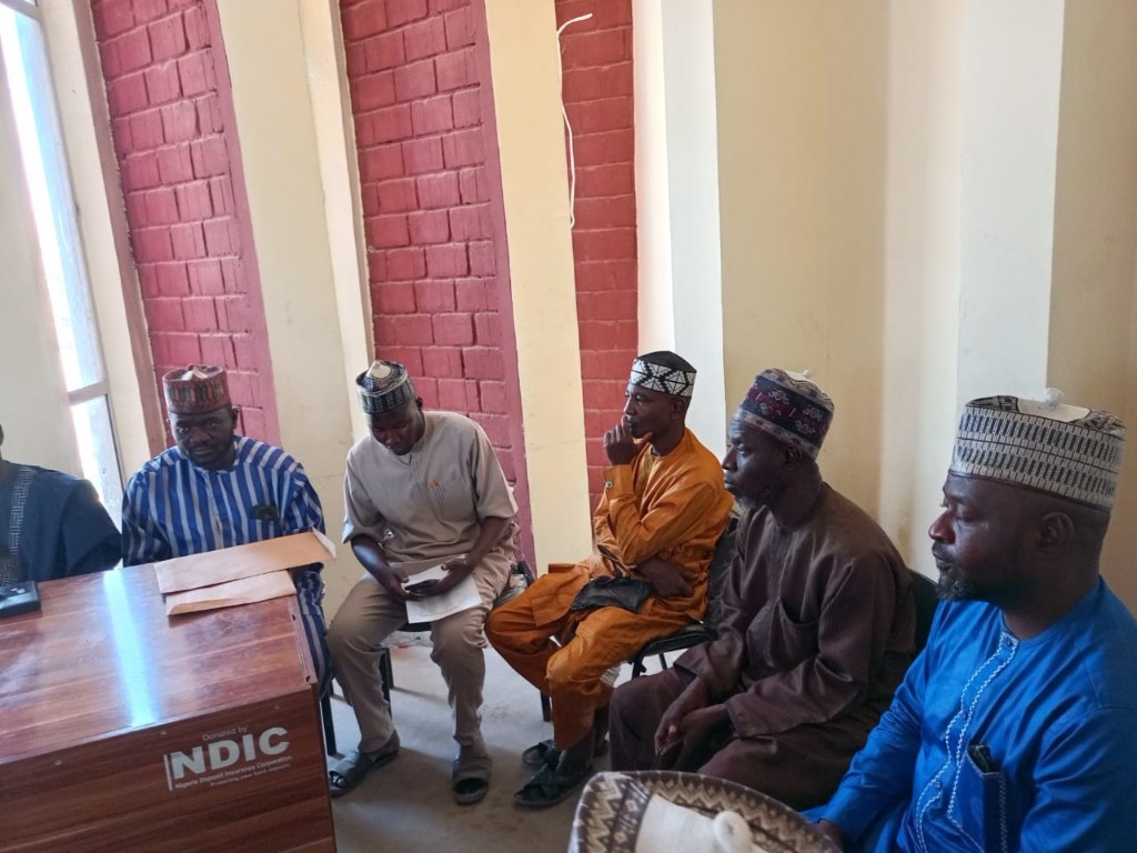 Members of the visit gathered along the table for the working session.
