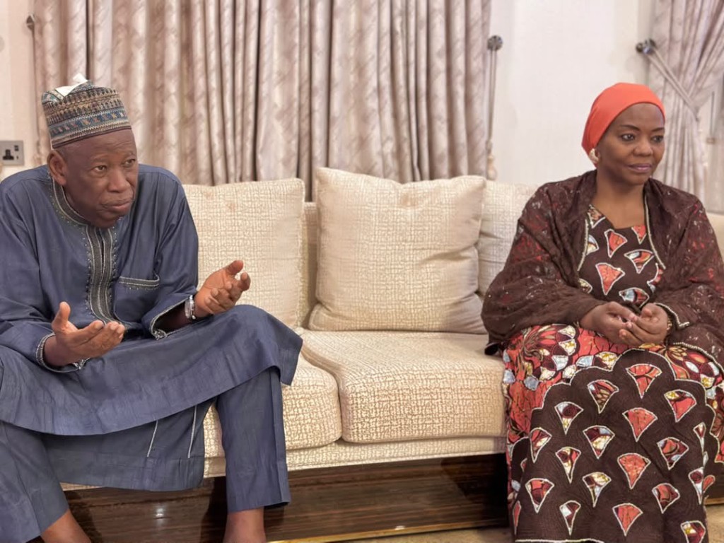 Dr. Abdullahi Umar Ganduje speaks with a member of the visit at his residence.